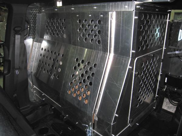 Perforated aluminum cage panels fitted behind the front seats inside the cruiser cabin
