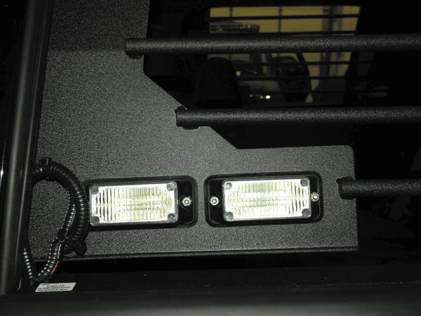 Two clear MR6 linear LED modules built into the end panel of the bar, viewed from inside the rear seat
