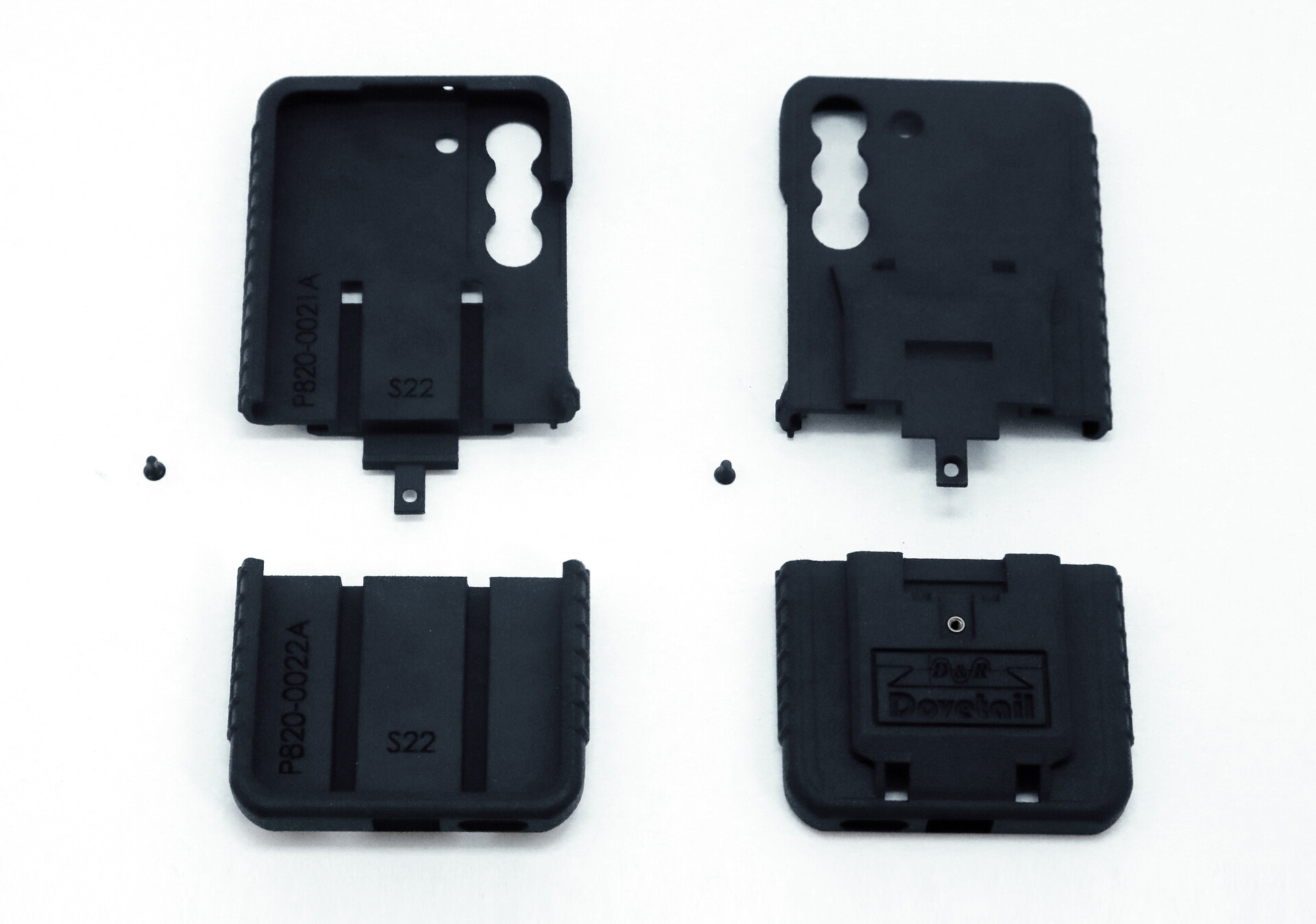 All four moulded parts and the two assembly screws laid out on white before assembly