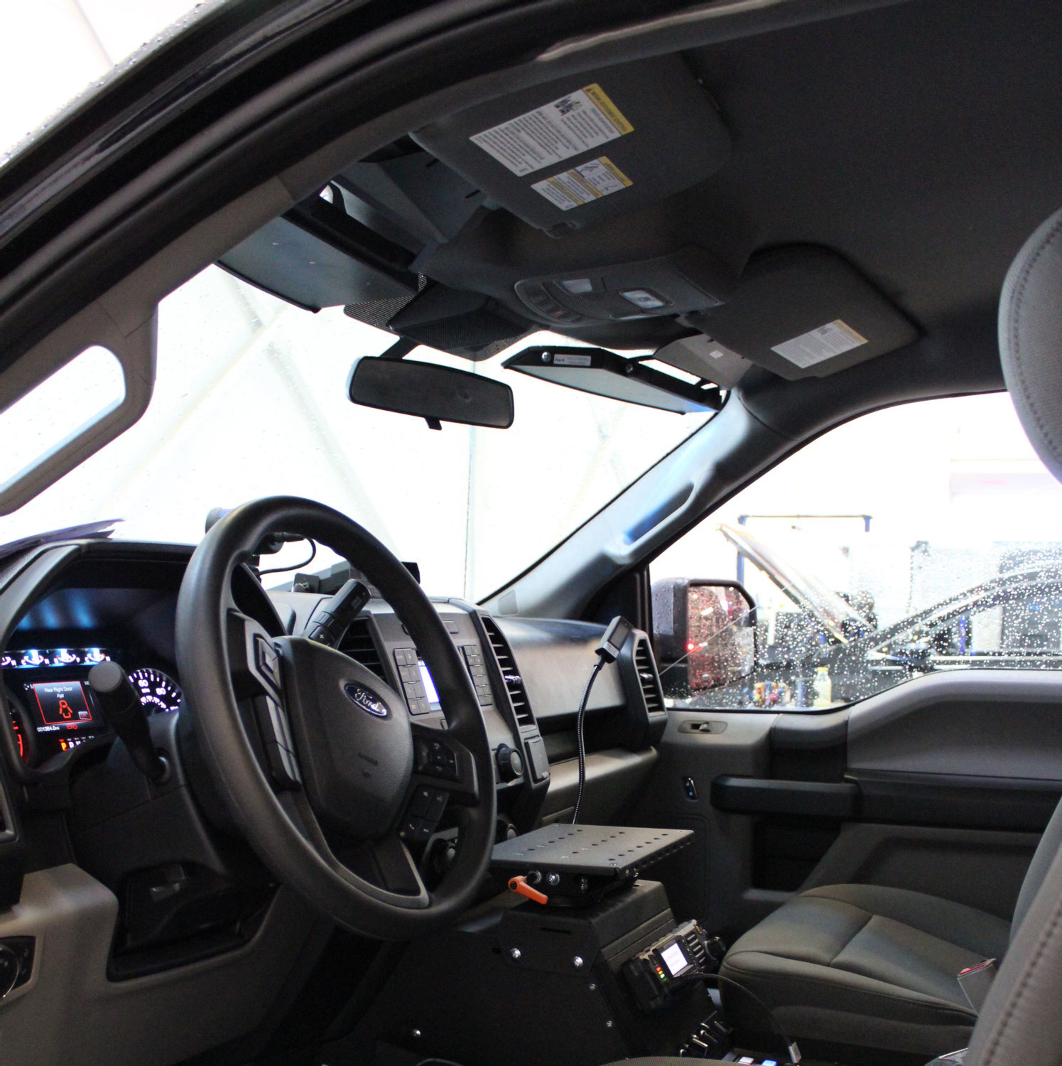 Ford F150 cab interior with the slim visor bar fitted along the windshield header beside the sun visors